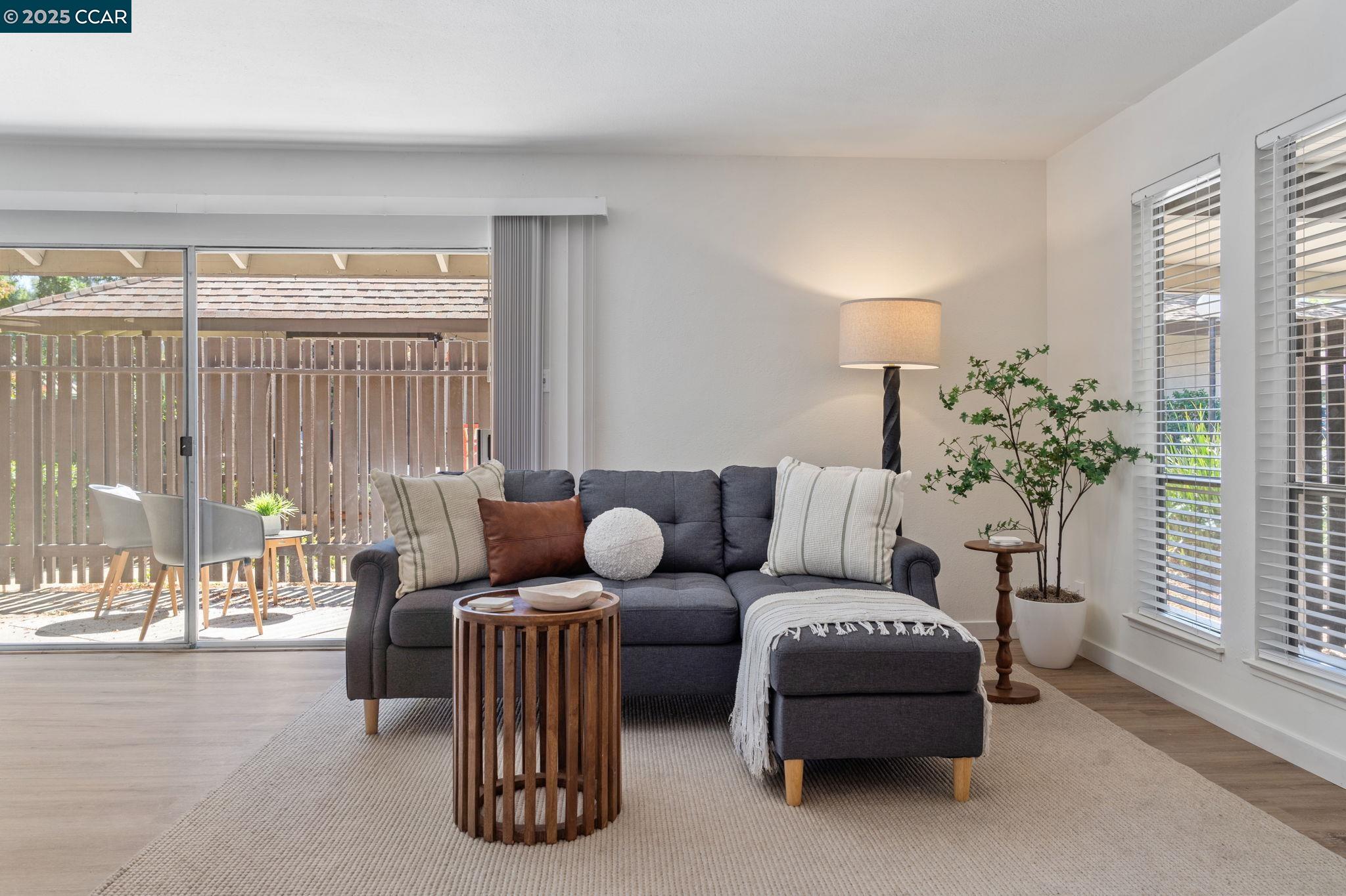5514 Roundtree Drive, Unit D Concord, CA 94521 - Photo 1 of 1 a living room with furniture and a large window