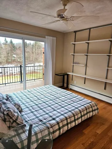 a bedroom with a bed and a lamp on table