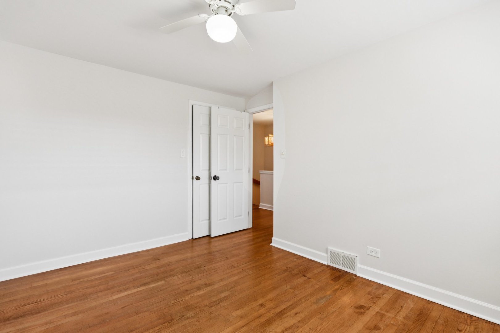 8666 Gregory Lane, Unit C Des Plaines, IL 60016 - Photo 14 of 30 a view of an empty room with wooden floor