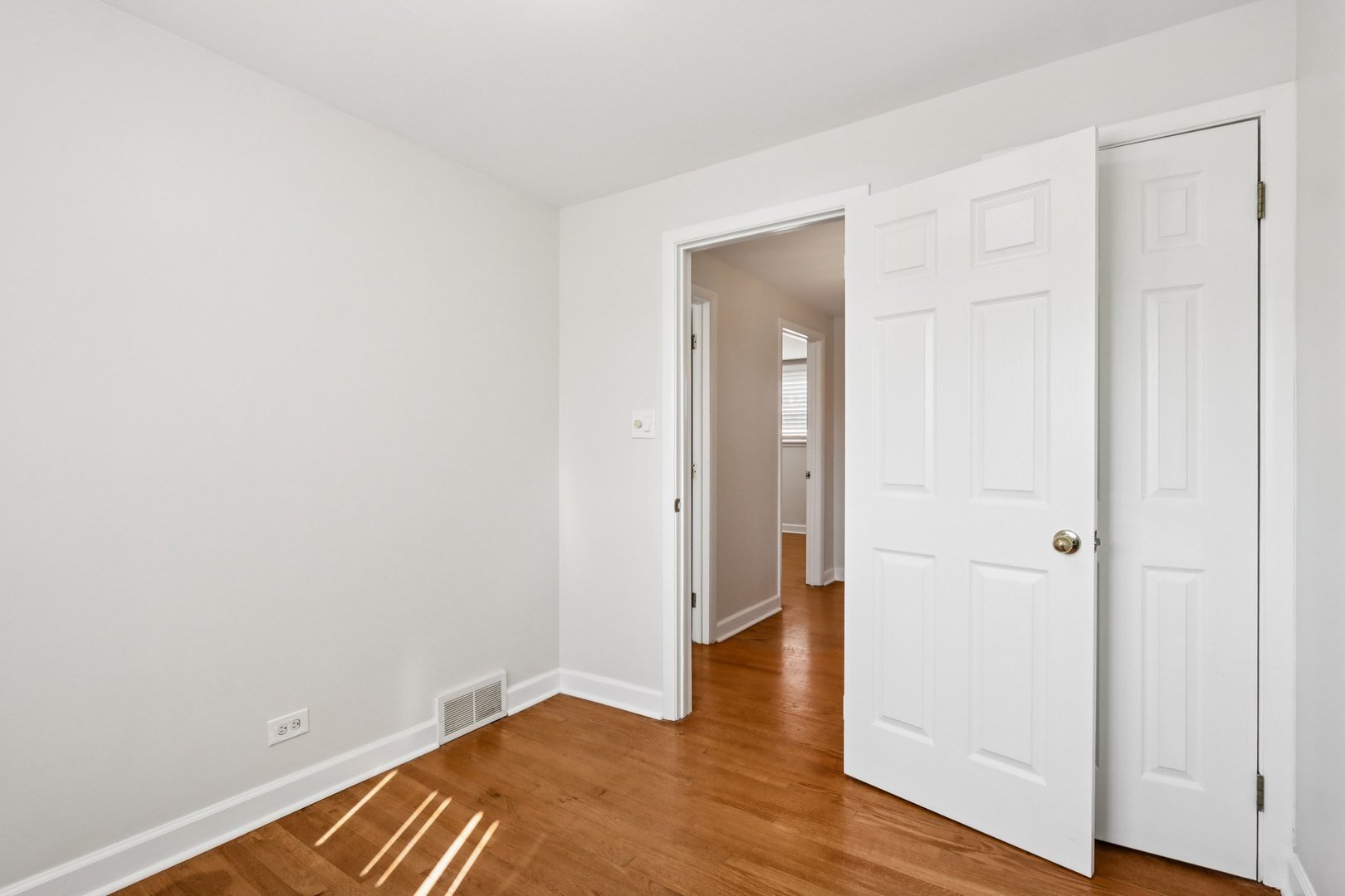 8666 Gregory Lane, Unit C Des Plaines, IL 60016 - Photo 16 of 30 an empty room with wooden floor & closet area