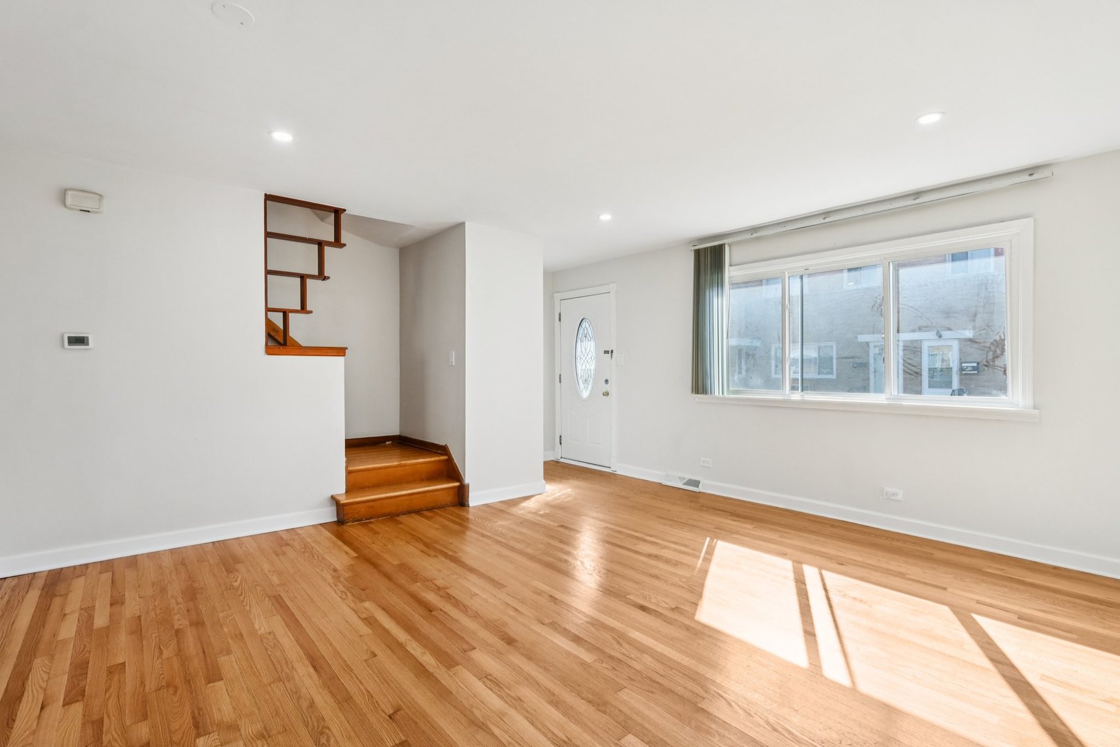 8666 Gregory Lane, Unit C Des Plaines, IL 60016 - Photo 3 of 30 a view of empty room with wooden floor and fan