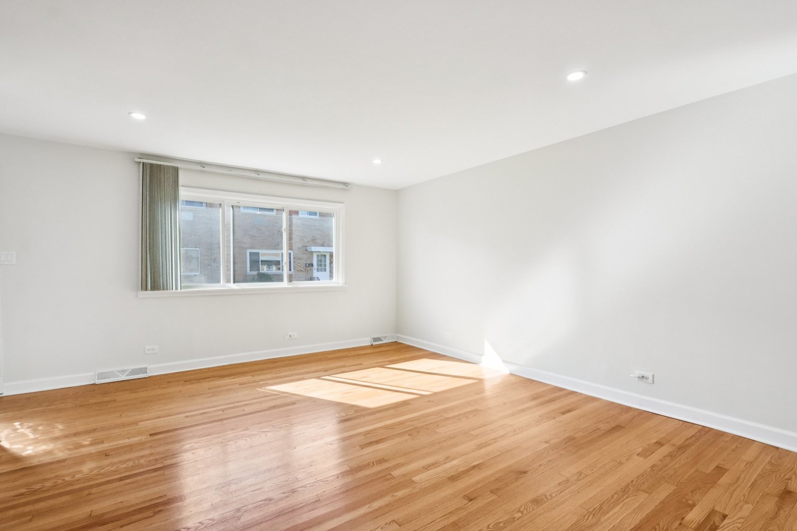 8666 Gregory Lane, Unit C Des Plaines, IL 60016 - Photo 4 of 30 a view of empty room with wooden floor and fan