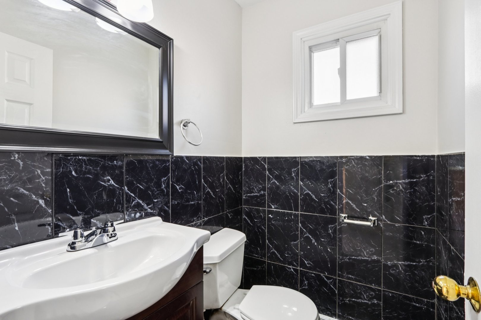 8666 Gregory Lane, Unit C Des Plaines, IL 60016 - Photo 8 of 30 a bathroom with a toilet a sink and mirror