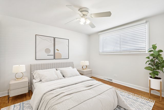 8666 Gregory Lane, Unit C Des Plaines, IL 60016 - Photo 9 of 30 a bedroom with a bed and a potted plant