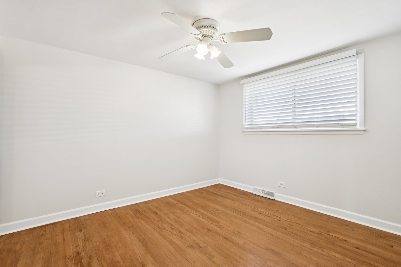 8666 Gregory Lane, Unit C Des Plaines, IL 60016 - Photo 10 of 30 wooden floor in an empty room with a window