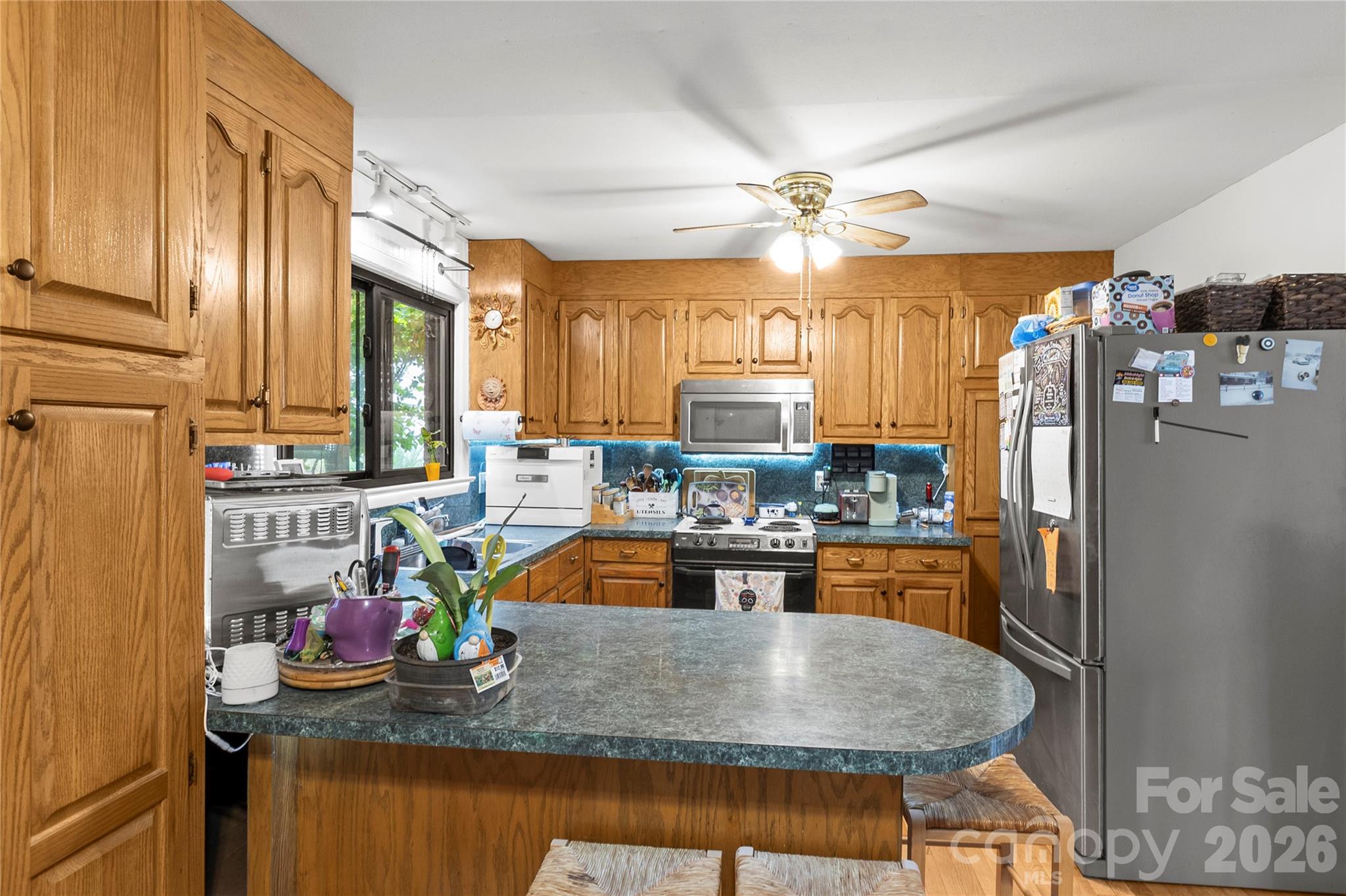 325 Swanson Road Lenoir, NC 28645 - Photo 13 of 35 a kitchen with stainless steel appliances granite countertop a sink refrigerator and microwave