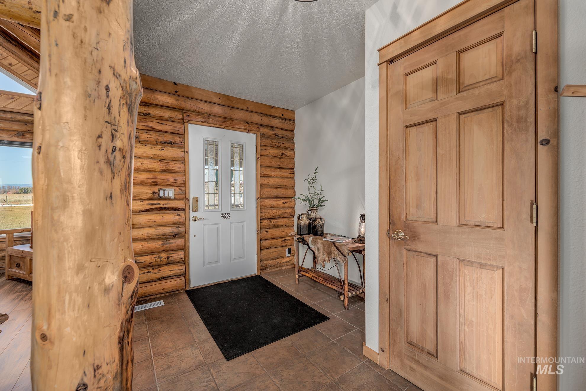 1855 Jones Road Weiser, ID 83672 - Photo 2 of 33 Foyer featuring rustic walls and a textured ceiling