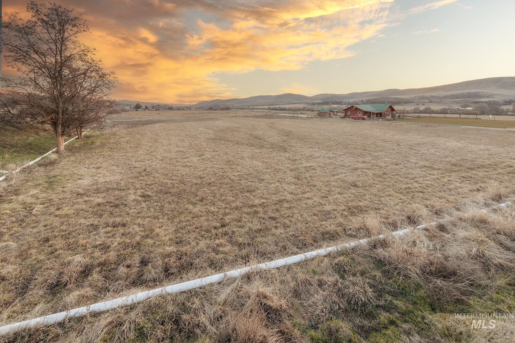 1855 Jones Road Weiser, ID 83672 - Photo 33 of 33 Yard at dusk featuring a view of countryside and a mountain view