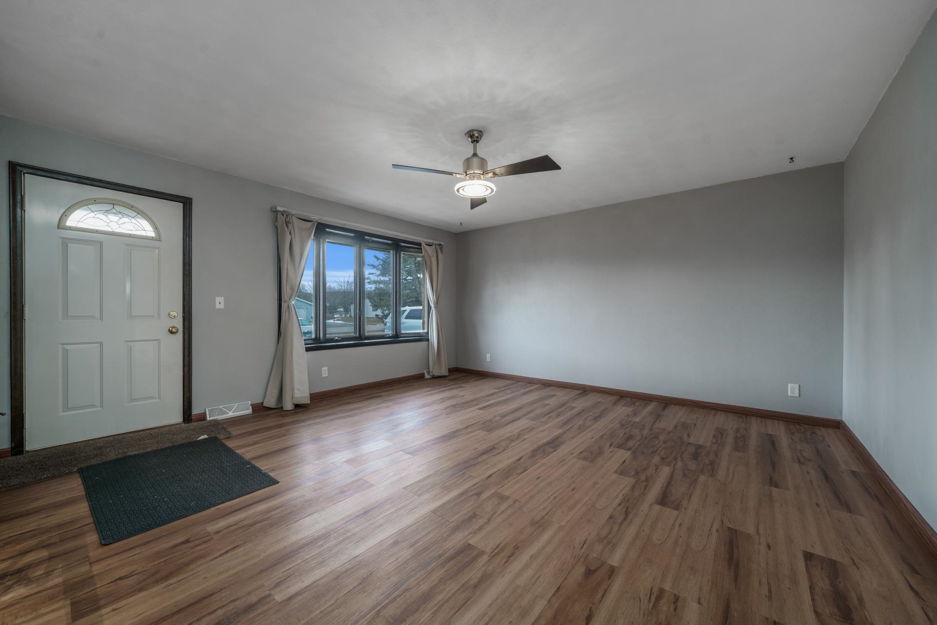 4082 Valerie Road Roscoe, IL 61073 - Photo 6 of 38 an empty room with wooden floor and windows