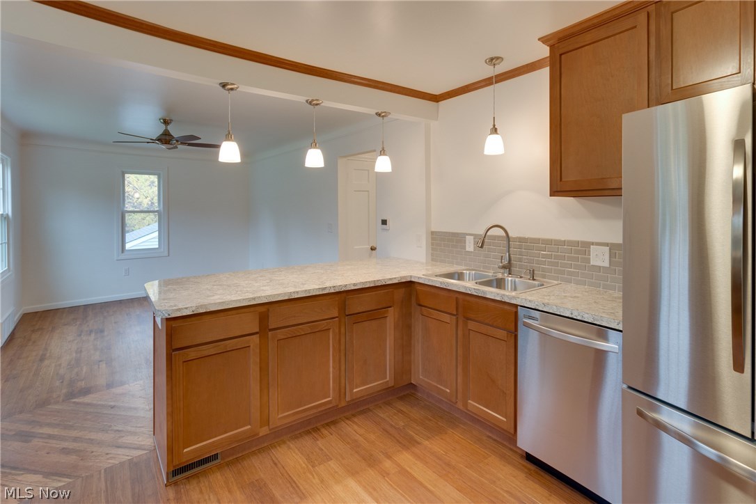 38705 Chardon Road Willoughby Hills, OH 44094 - Photo 7 of 35 Great view of the new sink and fixtures - Pendant light over breakfast bar area and sink - gleaming dishwasher and refrigerator in stainless steel