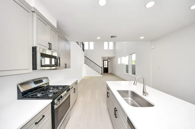 a kitchen with a stove and a sink