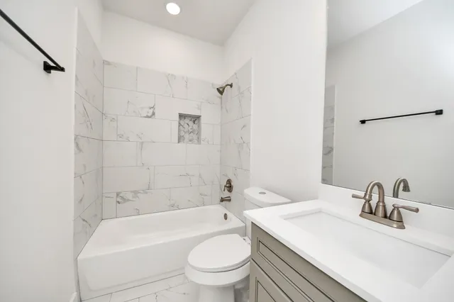 a view of a hallway with a large window and chandelier