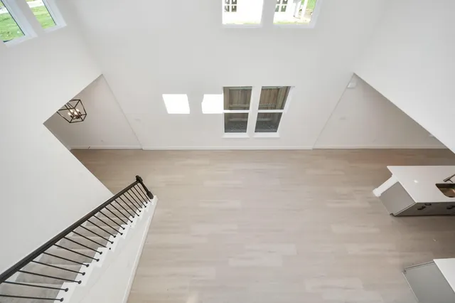 a view of a hallway with a ceiling fan and a window