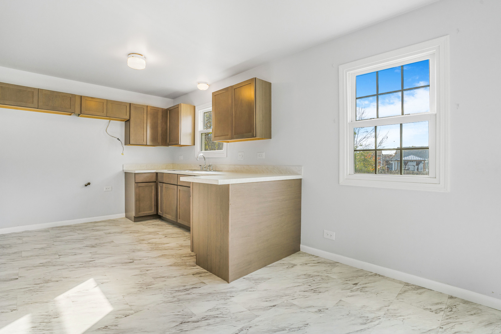 1388 Bow String Court Carol Stream, IL 60188 - Photo 8 of 24 a view of a kitchen with two sink and a window