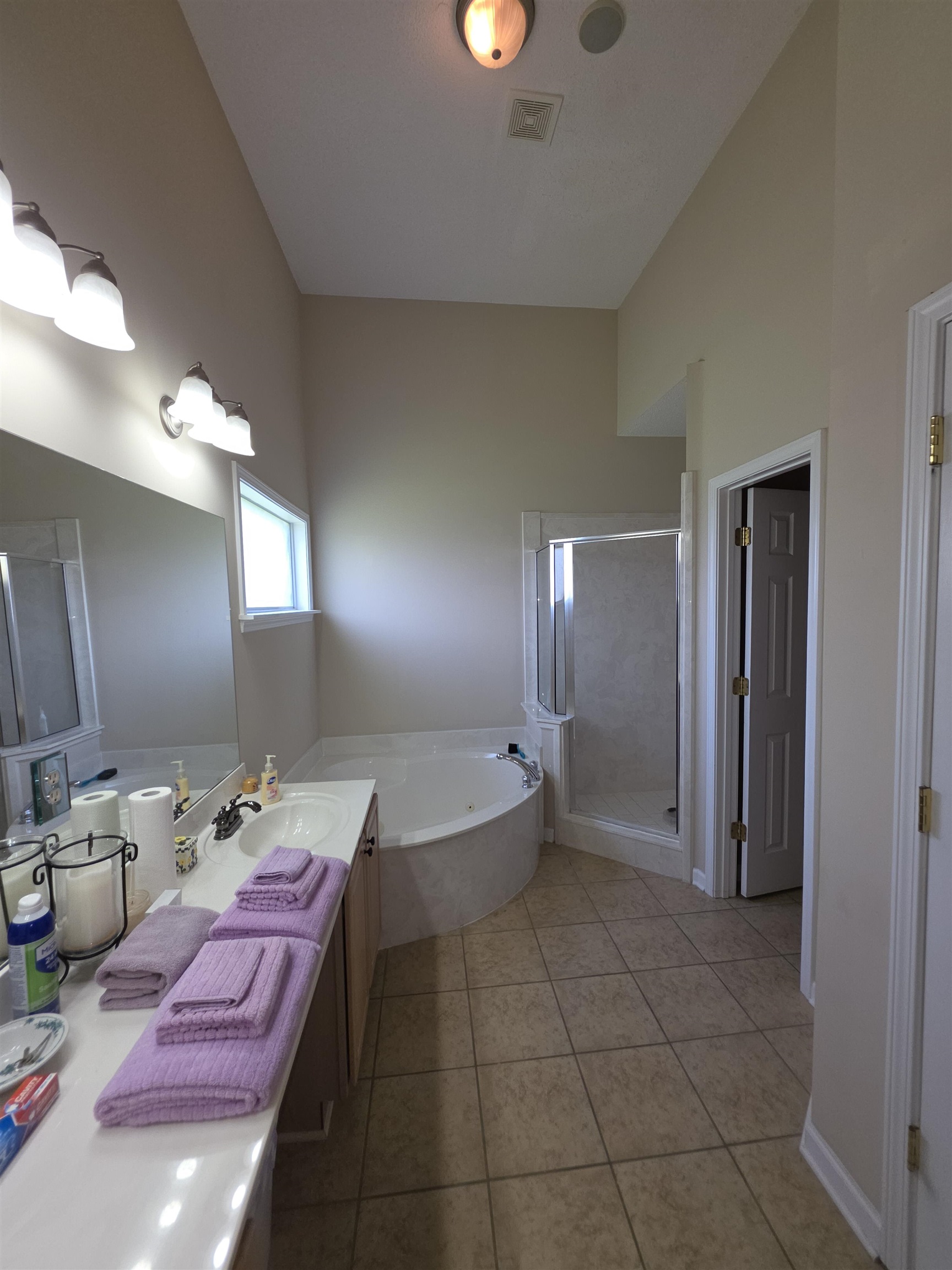 7253 Rourke Circle Memphis, TN 38125 - Photo 15 of 31 Spacious bathroom featuring a dual vanity, corner soaking tub, and separate glass-enclosed shower
