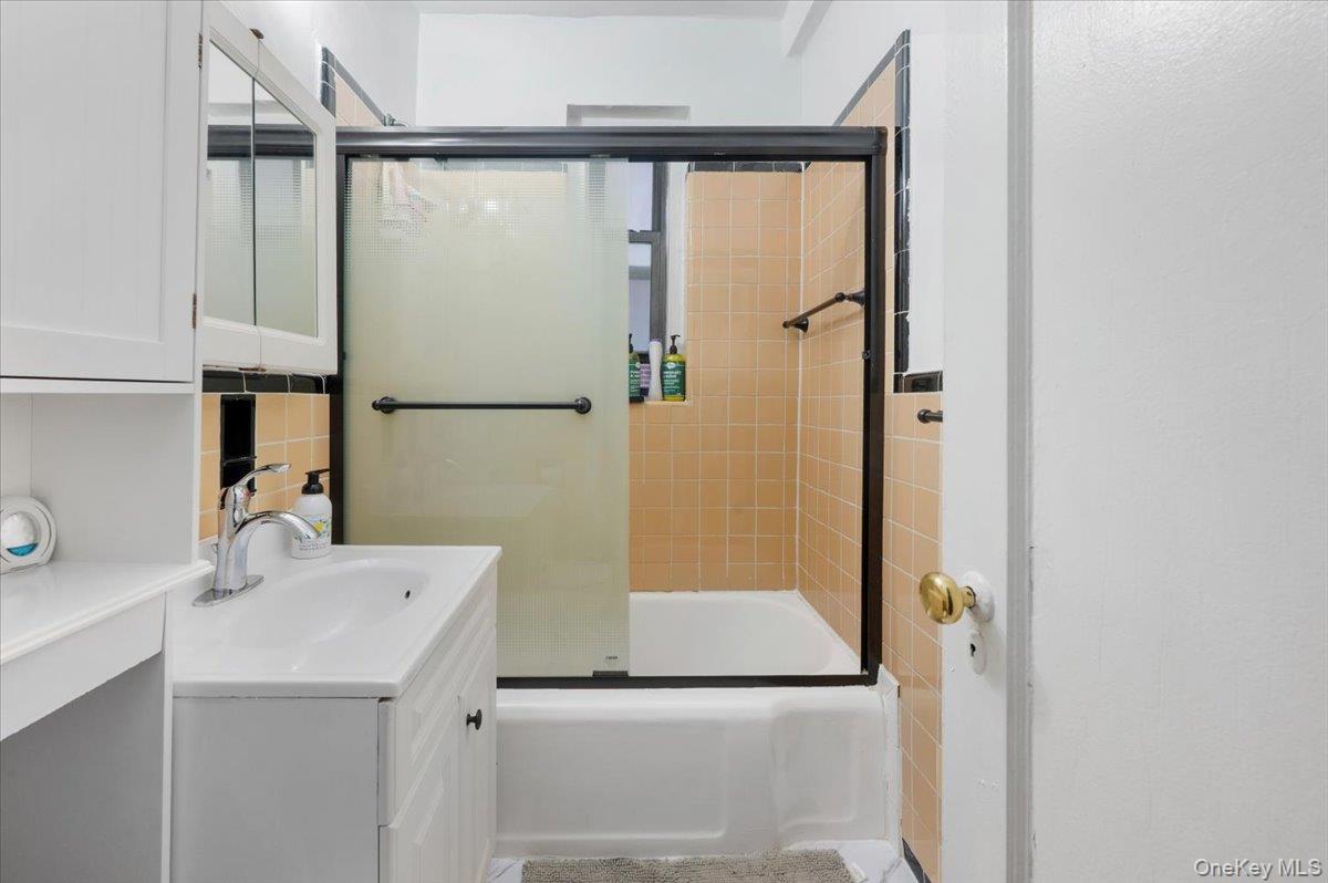 43-01 46th Street, Unit 2A Queens, NY 11104 - Photo 11 of 18 a bathroom with a sink and mirror