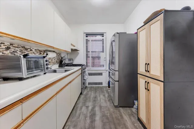a kitchen with stainless steel appliances a refrigerator and a stove top oven
