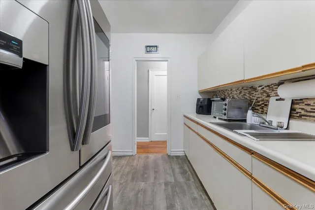 a kitchen with stainless steel appliances a sink and a refrigerator