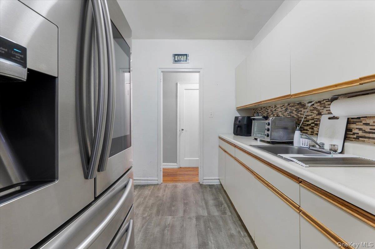 43-01 46th Street, Unit 2A Queens, NY 11104 - Photo 13 of 18 a kitchen with stainless steel appliances a sink and a refrigerator