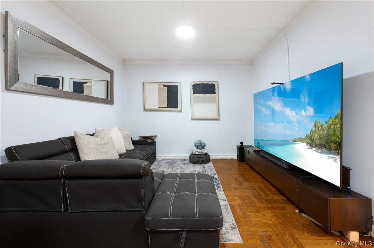 43-01 46th Street, Unit 2A Queens, NY 11104 - Photo 4 of 18 a living room with furniture and a flat screen tv