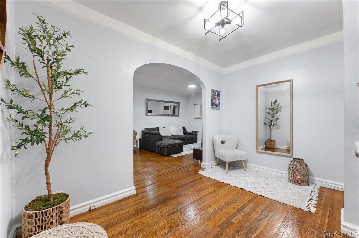 43-01 46th Street, Unit 2A Queens, NY 11104 - Photo 7 of 18 a living room with furniture and a chandelier