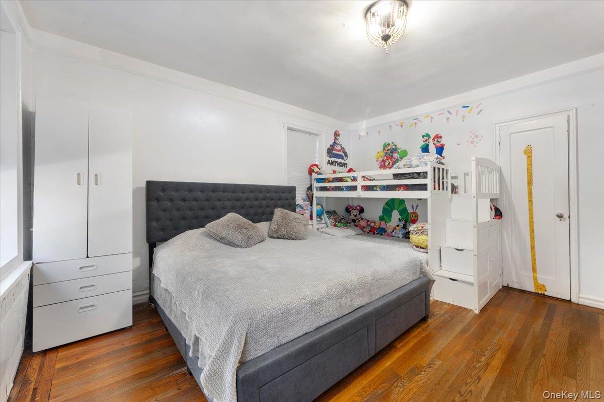 43-01 46th Street, Unit 2A Queens, NY 11104 - Photo 9 of 18 a bedroom with a bed and a ceiling fan