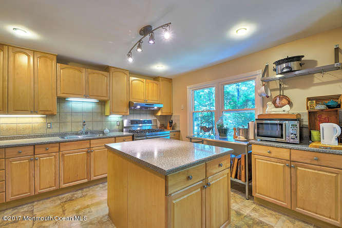 271 Jackson Pines Road Jackson, NJ 08527 - Photo 11 of 26 a kitchen with a sink window and cabinets