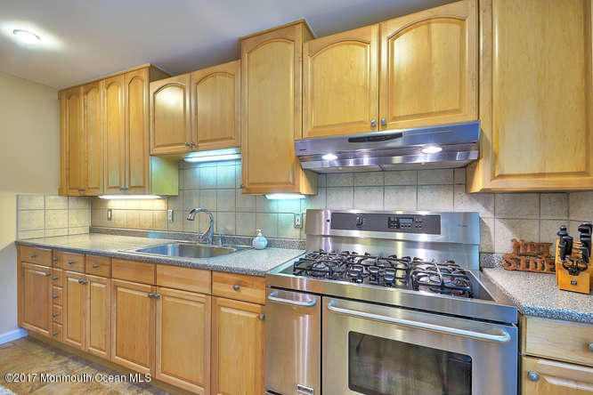 271 Jackson Pines Road Jackson, NJ 08527 - Photo 12 of 26 a kitchen with stainless steel appliances granite countertop a stove a sink and a microwave
