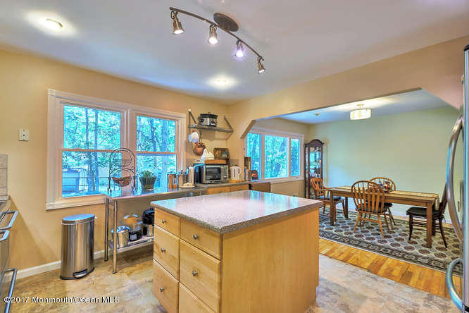 271 Jackson Pines Road Jackson, NJ 08527 - Photo 13 of 26 a view of a dining room with furniture a chandelier and wooden floor