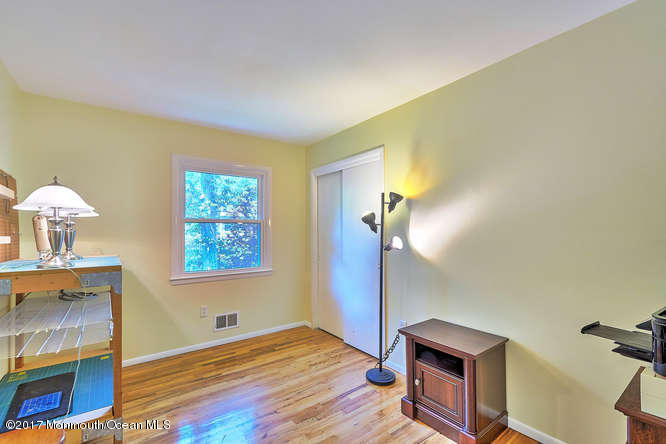 271 Jackson Pines Road Jackson, NJ 08527 - Photo 14 of 26 a view of empty room with a fireplace and wooden floor