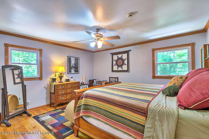 271 Jackson Pines Road Jackson, NJ 08527 - Photo 16 of 26 a bedroom with a bed and wooden floor