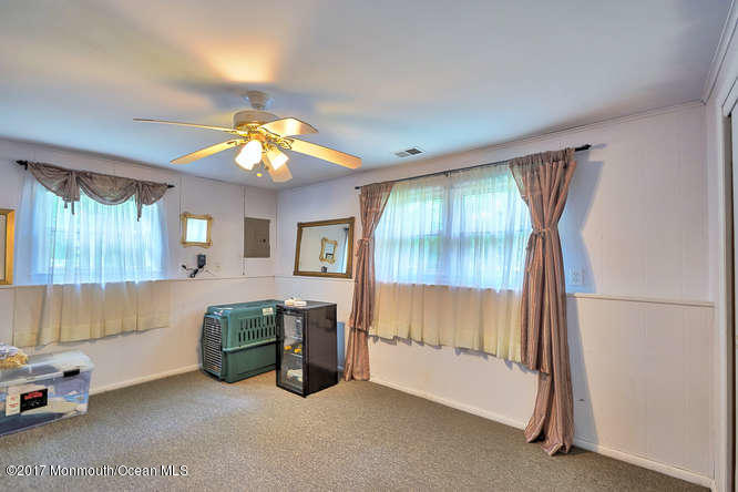 271 Jackson Pines Road Jackson, NJ 08527 - Photo 19 of 26 a room with furniture and a chandelier