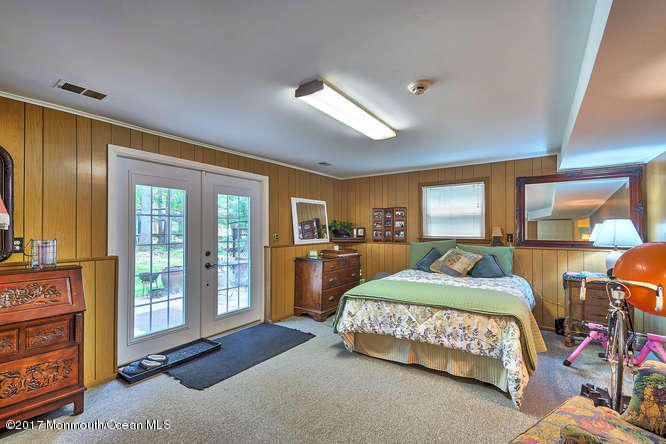 271 Jackson Pines Road Jackson, NJ 08527 - Photo 20 of 26 a bedroom with a bed window and walk in closet with wooden floor