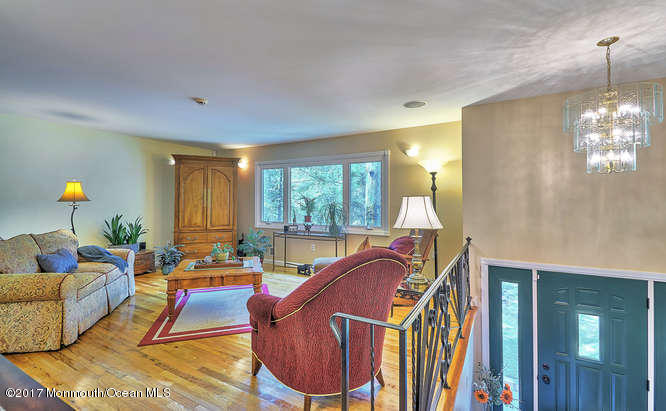 271 Jackson Pines Road Jackson, NJ 08527 - Photo 4 of 26 a living room with furniture a lamp and a chandelier