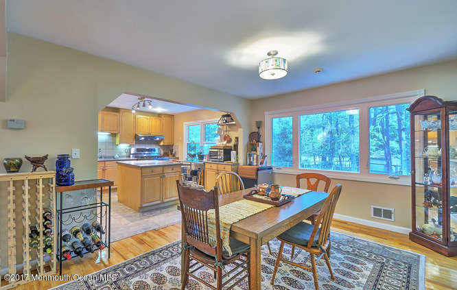 271 Jackson Pines Road Jackson, NJ 08527 - Photo 8 of 26 a dining room with furniture a rug and a chandelier