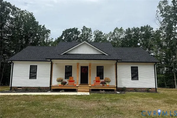a view of a house with a patio and a yard