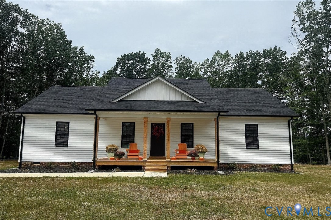 a view of a house with a patio and a yard