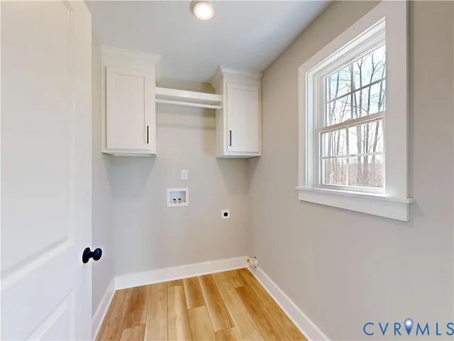 a view of a kitchen with wooden floor and cabinets