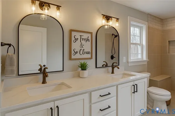 a bathroom with a sink a toilet and mirror