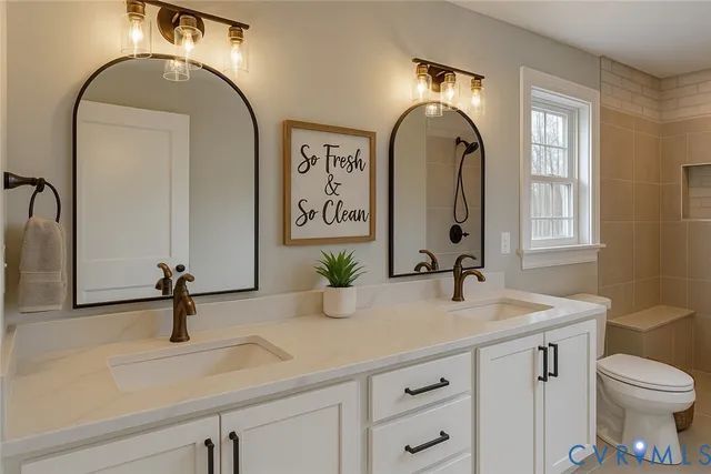 a bathroom with a sink a toilet and mirror