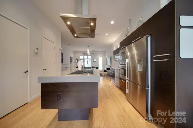 a kitchen with stainless steel appliances a sink stove and refrigerator