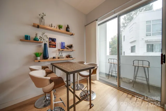 a view of a dining room with furniture window and wooden floor