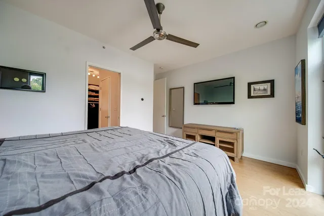 a bedroom with a bed and a tv