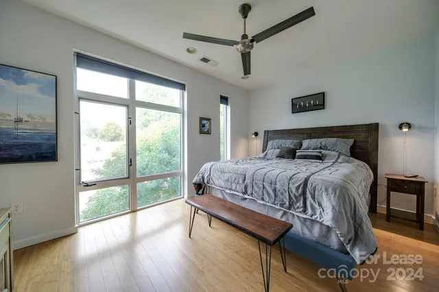 a bedroom with a large bed and a large window