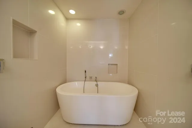 a white bath tub sitting in a bathroom