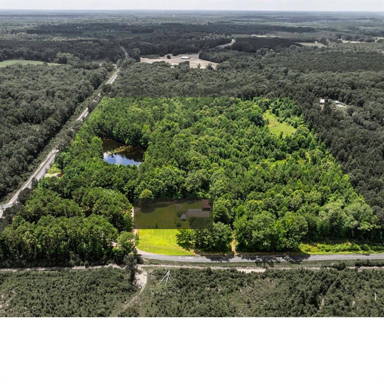 an aerial view of a house with a swimming pool