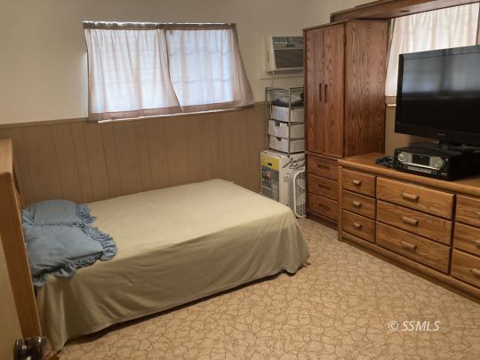 77 Adams Road Wofford Heights, CA 93285 - Photo 7 of 22 a bedroom with a bed and a flat tv screen on dresser