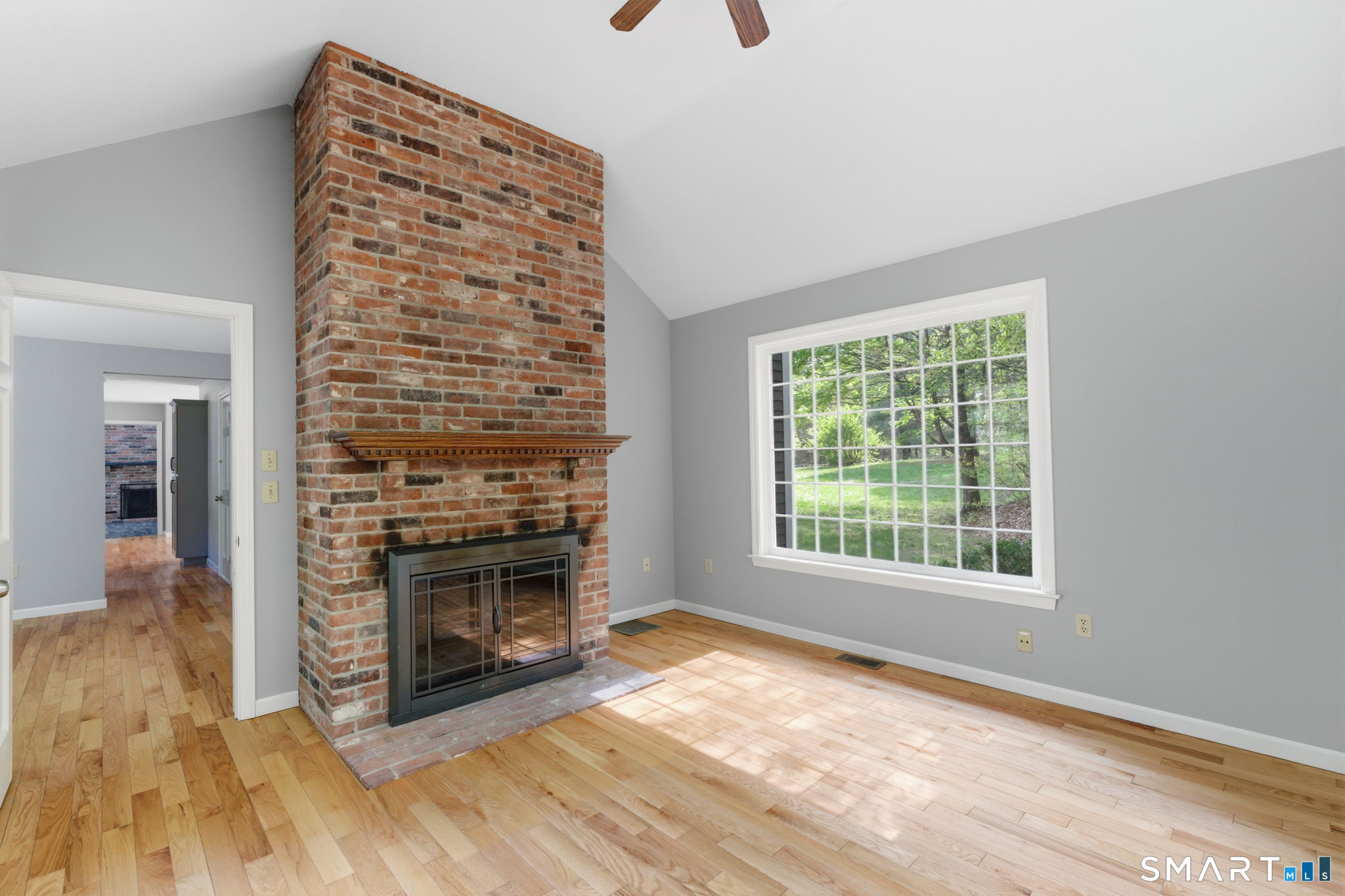 21 Greenwood Road North Granby, CT 06060 - Photo 18 of 40 a view of an empty room with wooden floor fireplace and a window