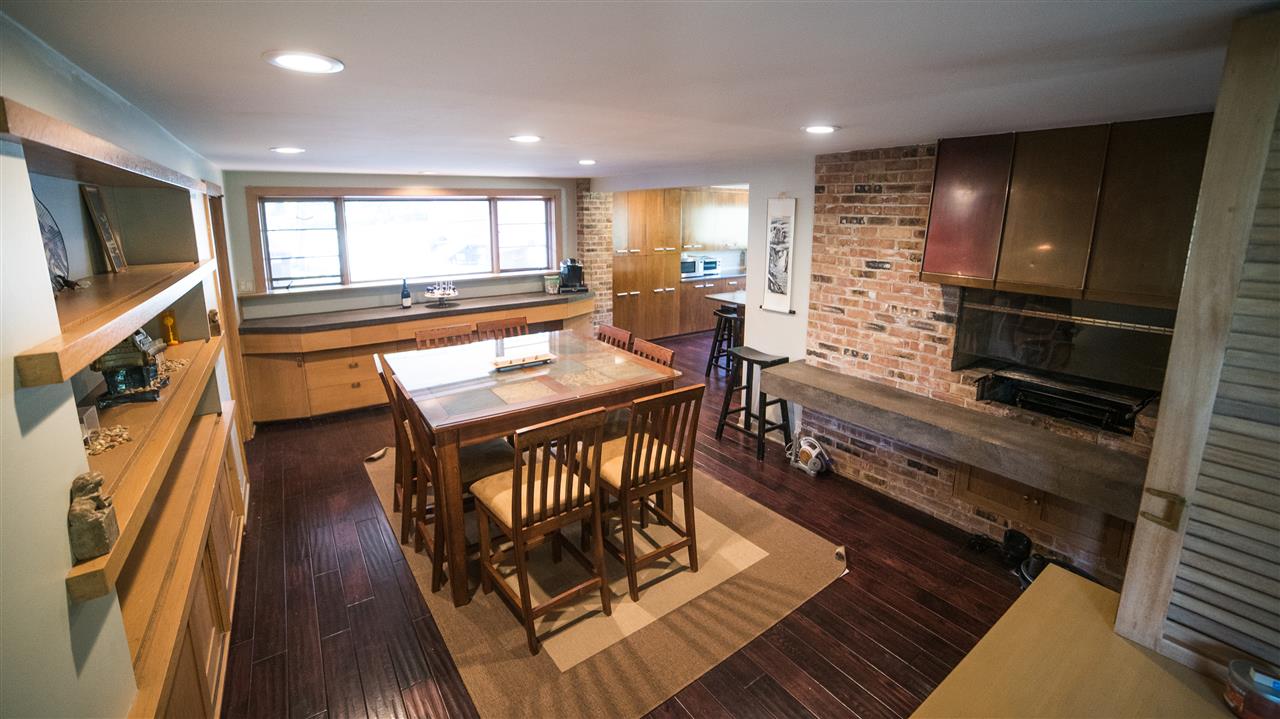 3802 Brookview Road Rockford, IL 61107 - Photo 11 of 25 a kitchen with a table chairs stove and wooden floor