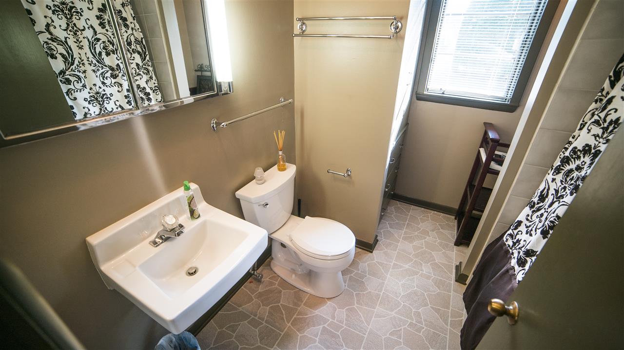 3802 Brookview Road Rockford, IL 61107 - Photo 20 of 25 a white toilet sitting next to a bathroom sink